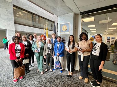 A group of 13 WWF Panda Ambassadors, dressed in shirts with the WWF logo, gathered in the halls of the us congress.
