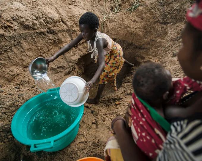 Girl filling buckets