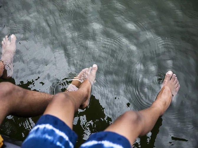 A child's feet floating in water