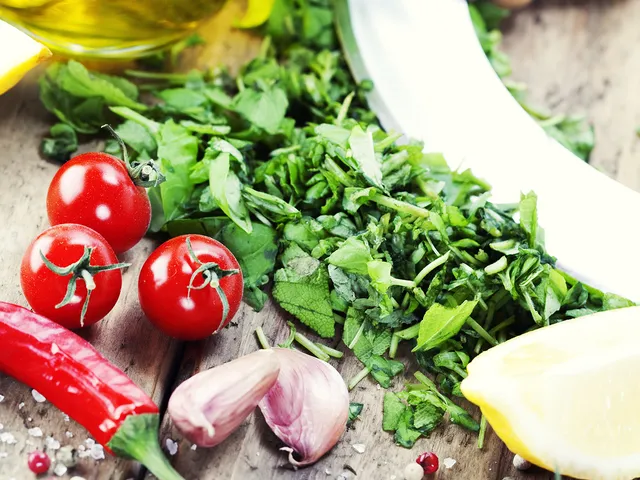 Vegetables sit on a table next to a knife