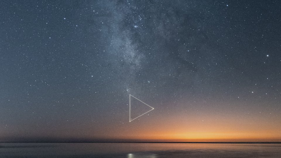 Milky Way and ocean landscape with triangle