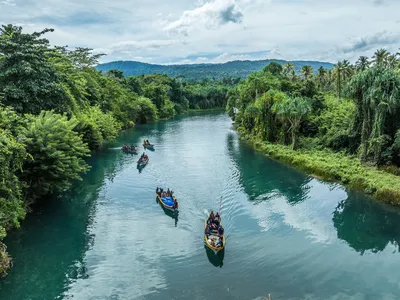 WWF staff and local community members travel in boats down the Esis River, Papua New Guinea
