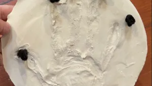 A craft featuring a hand print on plaster.