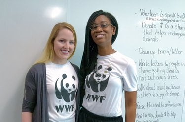 Two women standing in classroom wearing WWF shirts