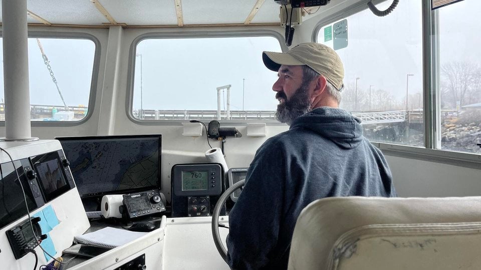 Brent Nappi steers his fishing boat to the dock in Long Island, Maine.