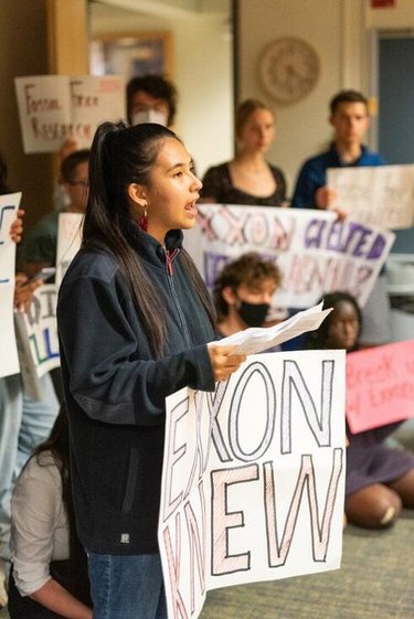 Alexia Leclercq holds a sign that reads 'Exxon Knew'