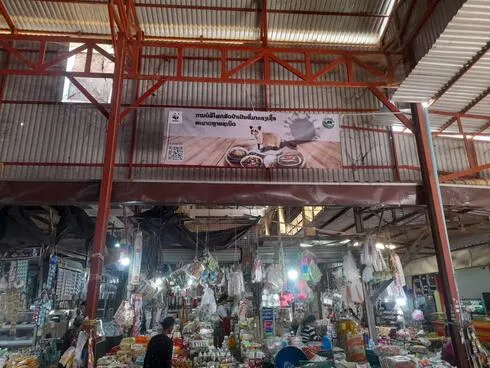A WWF banner hangs in an indoor marketplace