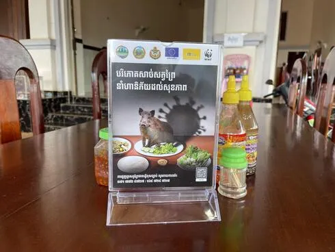 Campaign artwork on display in a restaurant in Cambodia