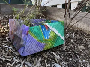 An origami butterfly in a planter.