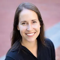 Allie Hines, wearing black, smiles at the camera