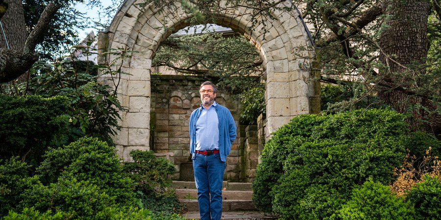 Moreno stands beneath a garden arch