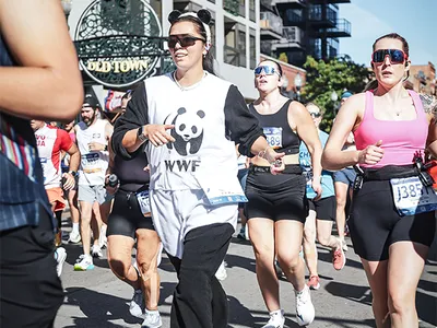 Woman running in a race in a panda outfit