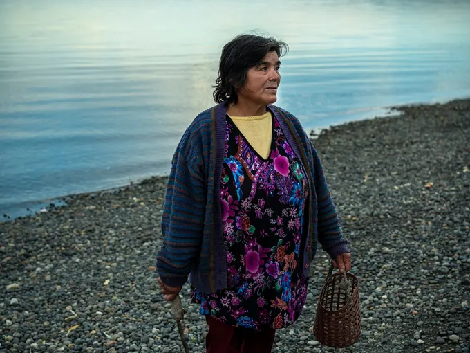 A woman stands on the beach
