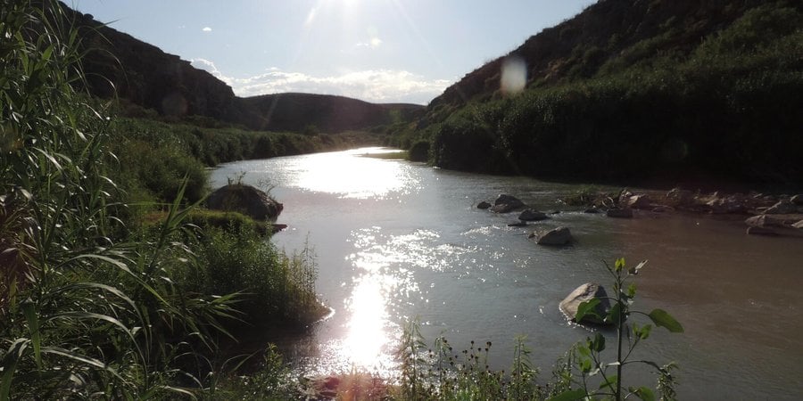 Sun shining over a river