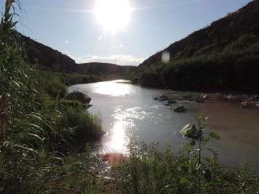 Sun shining over a river