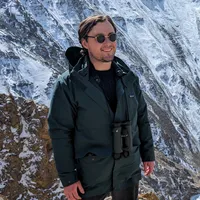 Daniel Hornett standing on a mountaintop