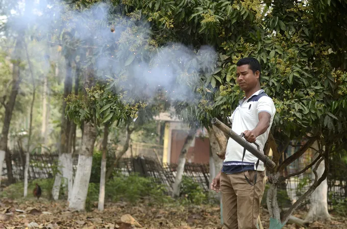 Man holding metal tube with smoke rising