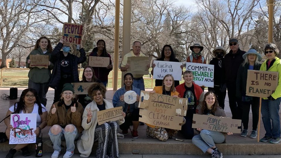 A group of young people with signs calling for climate action