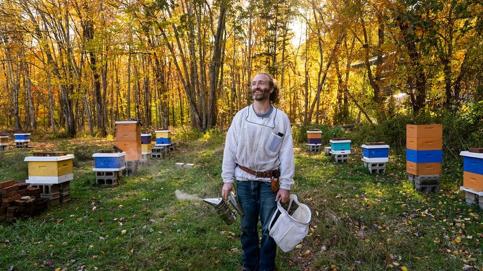 Burnett stands with his hives