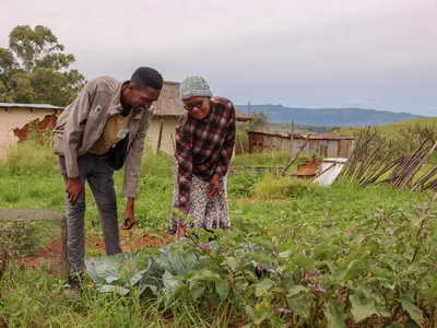 Tukulo “TK” Mtshayelo and his mother inside their garden in Black Diamond Village, Matatiele, South Africa