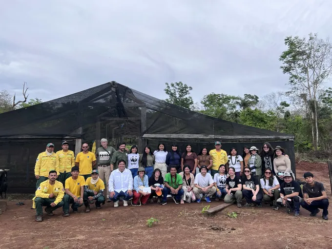 A posed group shot of around 30 people from WWF and the Paiter Surui community