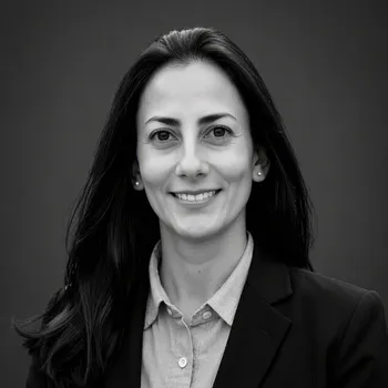 A headshot of a smiling woman