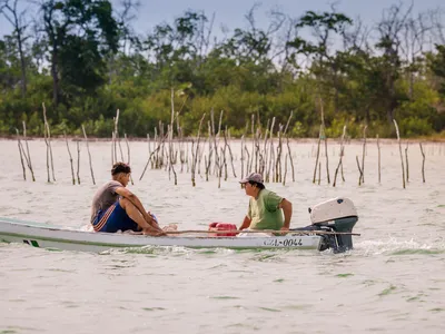 Two fishermen in a small boat