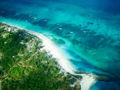 Aerial photo of beach with canoes alongside