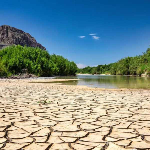 Cracked, drought-ridden soil makes up the bank of a portion of the Rio Grande-Rio Bravo