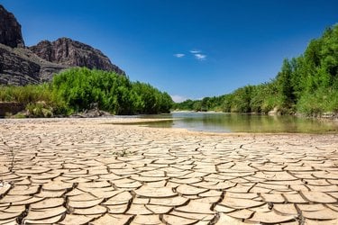 Cracked, drought-ridden soil makes up the bank of a portion of the Rio Grande-Rio Bravo