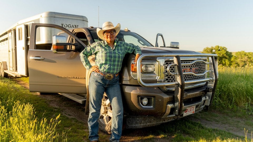 Alex Romero stands next to her truck on Rez Ranch, Rosebud Reservation