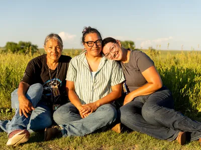Monica Rattling Hawk sits with her daughter Alex Romero and granddaughter Summer Romero