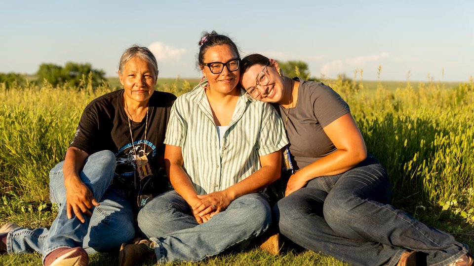 Monica Rattling Hawk sits with her daughter Alex Romero and granddaughter Summer Romero