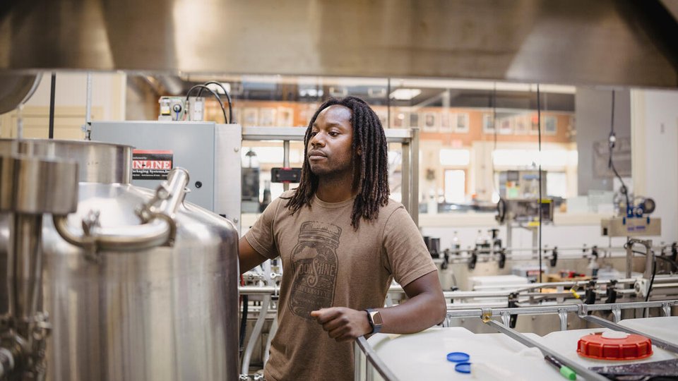 Donavan Williams checks equipment at the Delta Dirt Distillery