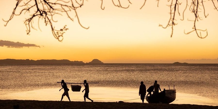 Fishers unload their catch at dusk in Ampasindava. Nosy Hara, Madagascar