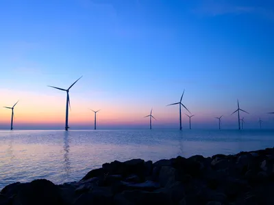 Offshore wind turbines at sunset