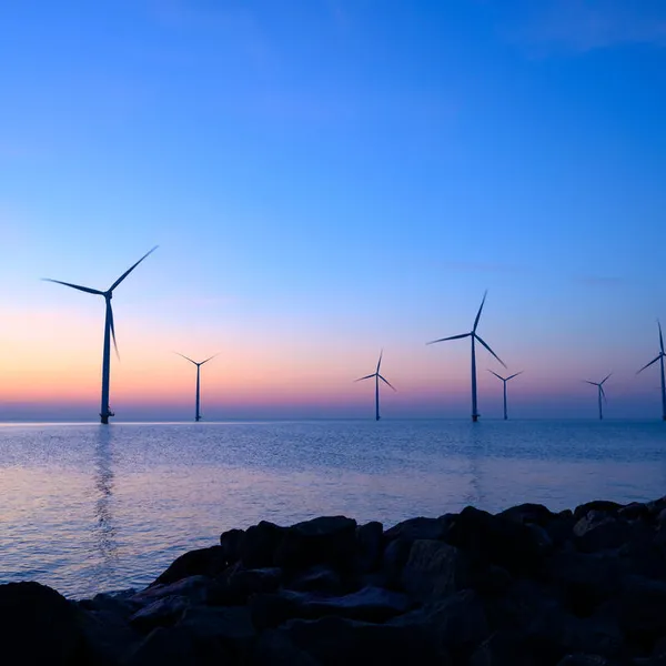 Offshore wind turbines at sunset