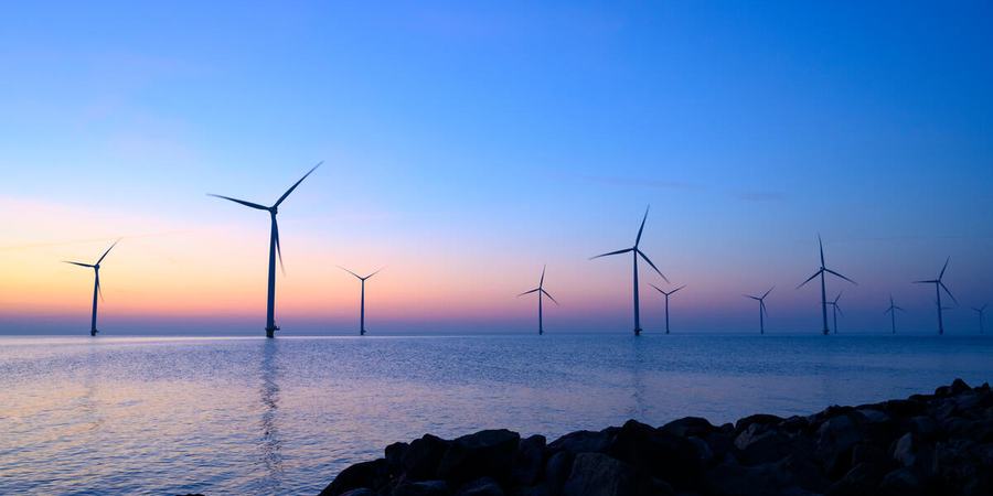 Offshore wind turbines at sunset