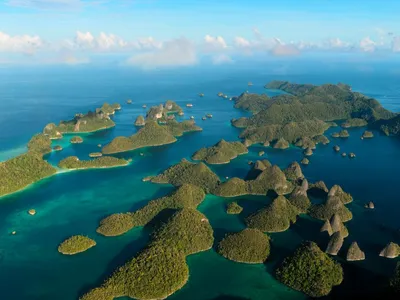 Aerial photo of green islands rising from blue ocean