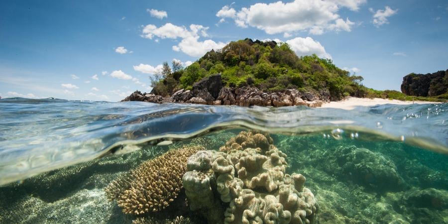Split view of above and underwater Andilana, Nosy Hara Marine Park, Madagascar