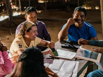 An Ecosystem Services Assessment (ESA) Technical Team, made up of members from the La Chorrera indigenous community and WWF-Colombia, review the data collected during an ecosystem service assessment of the forest surrounding La Chorrera, Predio Putumayo I