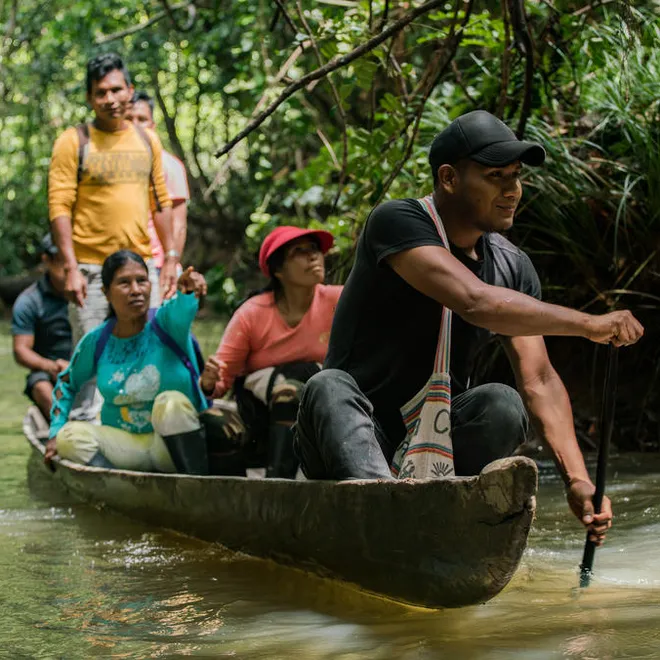 An Ecosystem Services Assessment Technical Team, made up of six members from the La Chorrera indigenous community head out along the Igara Paraná River in a canoe.