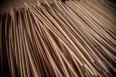 A close up of a large bundle of tan rattan cane