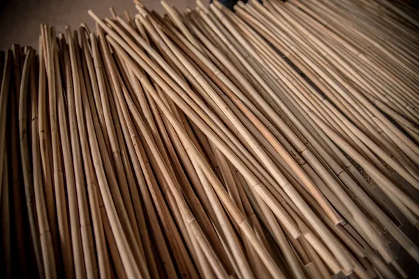 A close up of a large bundle of tan rattan cane
