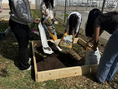 High school students expand garden beds