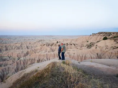 Two men standing on rock formations