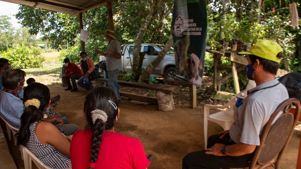 People listening in an outdoor meeting