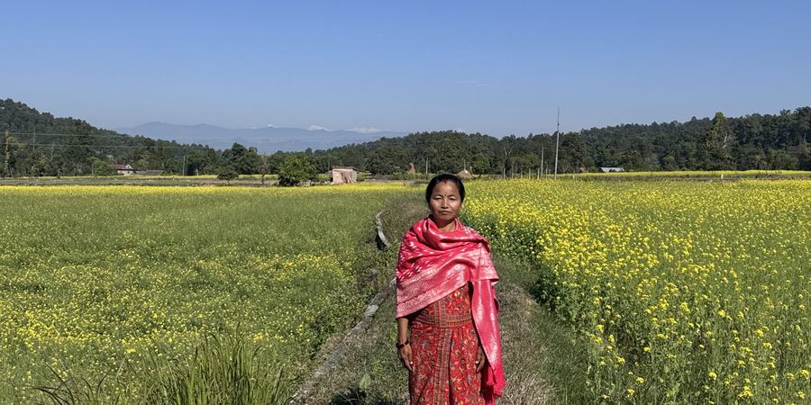 Purna-Devi-Magar-stands-proudly-in-her-mustard-field-fed-by-multipurpose-pond-in-Magar-Village-Rajpur-RM