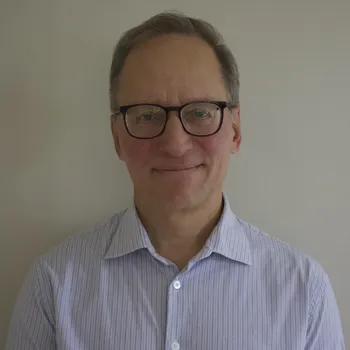 Headshot of a man in a button down shirt