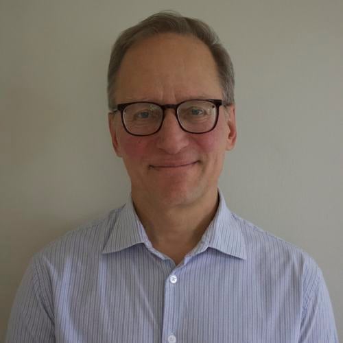 Headshot of a man in a button down shirt